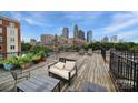 Spacious rooftop deck with seating, planters and city views at 515 N Church St # 305, Charlotte, NC 28202