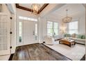 Elegant foyer showcasing hardwood floors, decorative lighting, and an inviting view into the living room at 5518 Morris Hunt Dr, Fort Mill, SC 29708