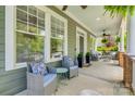 Cozy front porch featuring comfortable seating, potted plants, and a ceiling fan for outdoor enjoyment at 5518 Morris Hunt Dr, Fort Mill, SC 29708