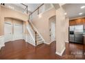 Grand foyer with soaring ceilings, hardwood floors, staircase, and arched doorways, creating an elegant entrance at 7130 Maricopa Rd, Charlotte, NC 28277