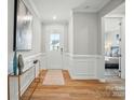 Welcoming entryway featuring hardwood floors, wainscoting, and natural light at 9930 Cask Way, Huntersville, NC 28078