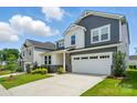 Beautiful home showcases a two-car garage, well-maintained lawn, and stylish architecture under a partly cloudy sky at 9930 Cask Way, Huntersville, NC 28078
