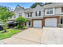 Attractive townhome with attached garages, manicured lawn, and gray siding that provides a welcoming street view at 10063 Reindeer Way Ln, Charlotte, NC 28216
