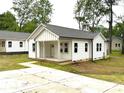 Charming white home with a cozy front porch and a long concrete driveway at 1102 Grady St, Salisbury, NC 28144
