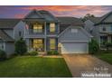 Charming two-story home with a welcoming front porch and attached two-car garage at 1306 San Gabriel Ave, Charlotte, NC 28214