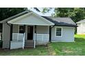 Charming front of house featuring a cozy porch with black posts and white railings at 148 Forest Heights Dr, McAdenville, NC 28101