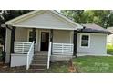 Charming front of house featuring a cozy porch with black posts and white railings at 148 Forest Heights Dr, McAdenville, NC 28101