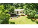 Charming home nestled among mature trees, featuring a well-manicured lawn at 155 Springdale Acres Dr, Mooresville, NC 28115