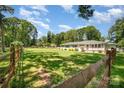 Spacious front yard enclosed by wooden fencing, showcasing the property's generous lot size at 1632 Charles Raper Jonas Hwy, Mount Holly, NC 28120