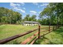 A sprawling front yard with a charming fence, offering privacy and curb appeal at 1632 Charles Raper Jonas Hwy, Mount Holly, NC 28120