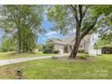 Well-maintained property with mature trees and a long driveway leading to the charming home's entrance at 187 Spring Run Dr, Mooresville, NC 28117