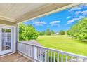 Balcony view overlooking a lush green landscape with trees and homes in the distance at 187 Spring Run Dr, Mooresville, NC 28117