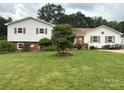 Well-maintained home with a green lawn, mature trees, and lovely curb appeal at 1895 Sandy Cir, Newton, NC 28658