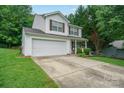 Traditional two-story home featuring an attached garage and a concrete driveway at 1912 8Th Se St, Hickory, NC 28602
