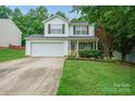 Charming two-story home featuring a well-manicured lawn and attached two car garage at 1912 8Th Se St, Hickory, NC 28602