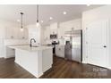 Beautiful kitchen with white cabinets, stainless steel appliances, and a large center island at 2043 Sadler Woods Ln, Charlotte, NC 28214
