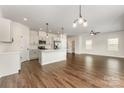 Open concept kitchen with white cabinets, stainless steel appliances, and a large island with pendant lighting at 2051 Sadler Woods Ln, Charlotte, NC 28214