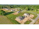 Sprawling aerial view of a new construction homes and a well-maintained green space at 21013 Running Creek Dr # 4, Locust, NC 28097