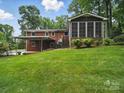 Exterior rear view of brick home with a screened porch and covered parking at 220 Lakeview Dr, Belmont, NC 28012