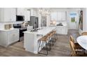 Modern kitchen featuring white cabinets, stainless steel appliances, and an island with seating at 2485 Hedgecliff Rd, Kannapolis, NC 28025