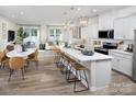 Open concept kitchen with island, seating, modern appliances, and seamless flow to the living area at 2485 Hedgecliff Rd, Kannapolis, NC 28025
