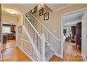 Welcoming foyer features hardwood floors, staircase, and views into the kitchen and bedroom at 3500 Sunningdale Ln # 221, Statesville, NC 28625