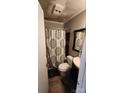 Compact bathroom with a patterned shower curtain, modern vanity, and neutral color scheme at 3715 Patricia Nw Dr, Concord, NC 28027