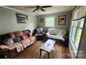 Cozy living room with hardwood floors, comfortable seating, and ample natural light at 3715 Patricia Nw Dr, Concord, NC 28027