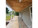 Spacious covered porch with painted wooden ceiling, perfect for outdoor seating and enjoying the surroundings at 38 Holly St, Great Falls, SC 29055