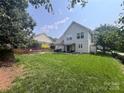 Large backyard featuring a patio, trampoline and lush green grass at 418 Eastway Sw Ln, Conover, NC 28613