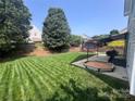 Spacious backyard with fresh cut grass, a sandbox and covered patio at 418 Eastway Sw Ln, Conover, NC 28613
