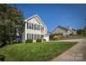 Beautifully landscaped home with a lush green lawn, complementing the well-maintained neighborhood at 418 Eastway Sw Ln, Conover, NC 28613