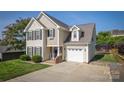 Inviting two-story home with an attached garage and mature landscaping in a peaceful neighborhood at 418 Eastway Sw Ln, Conover, NC 28613