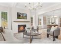Bright living room with fireplace, wood mantel, modern furnishings, and abundant natural light at 514 W Cama St, Charlotte, NC 28217