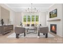 Well-lit living room featuring modern furnishings, large windows, and a cozy fireplace at 514 W Cama St, Charlotte, NC 28217