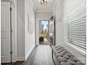 Bright entryway featuring hardwood floors, a decorative bench, and natural light streaming through the front door at 518 Palmarosa St, Fort Mill, SC 29715