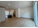 Bright living room featuring modern recessed lighting, open layout, and large sliding glass doors at 6013 Countess Dr # 51, Charlotte, NC 28217