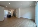 Bright living room with hardwood floors, recessed lighting, and open floor plan into the kitchen at 6013 Countess Dr # 51, Charlotte, NC 28217