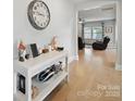Inviting entryway with light wood floors, console table and decorative elements leading to living area at 6017 Fazio Ct, Harrisburg, NC 28075