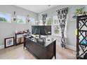 Cozy home office with modern desk setup, stylish patterned curtains, and ambient natural light at 6017 Fazio Ct, Harrisburg, NC 28075