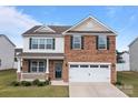Well-maintained two-story home featuring a classic brick facade and a two-car garage, set in a residential neighborhood at 7172 Teague Dr, Gastonia, NC 28056