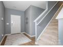 Inviting entryway with a staircase, neutral decor, and a patterned rug for a cozy welcome at 7209 Cuddington Dr, Charlotte, NC 28215