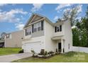 Attractive two-story home featuring a two-car garage, neat landscaping, and a welcoming front entrance at 7209 Cuddington Dr, Charlotte, NC 28215