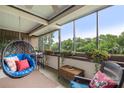 Cozy screened porch featuring comfortable seating and potted plants overlooking the community pond at 7329 Winery Ln, Charlotte, NC 28227