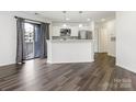 Modern kitchen with white cabinets, stainless steel appliances, and breakfast bar overlooking the dining area at 8183 Cedar Glen Dr, Charlotte, NC 28212