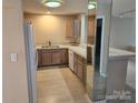 Efficient kitchen with laminate countertops, wood cabinets, and white appliances at 854 Southwest Dr, Davidson, NC 28036