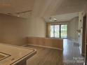 Open-concept living room with fireplace, ceiling fan, and sliding glass doors to balcony at 854 Southwest Dr, Davidson, NC 28036