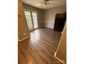 Bright dining area featuring wood-look floors, neutral walls, and a door leading to the outdoors at 921 Nottingham Dr # 6, Gastonia, NC 28054