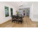 Open-concept dining room with modern light fixtures and stainless steel appliances in the adjacent kitchen at 940 N New Hope Rd, Gastonia, NC 28054