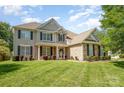 Beautiful exterior elevation view featuring a two-story home with manicured lawn and mature trees at 9814 Tompkins Ln, Waxhaw, NC 28173